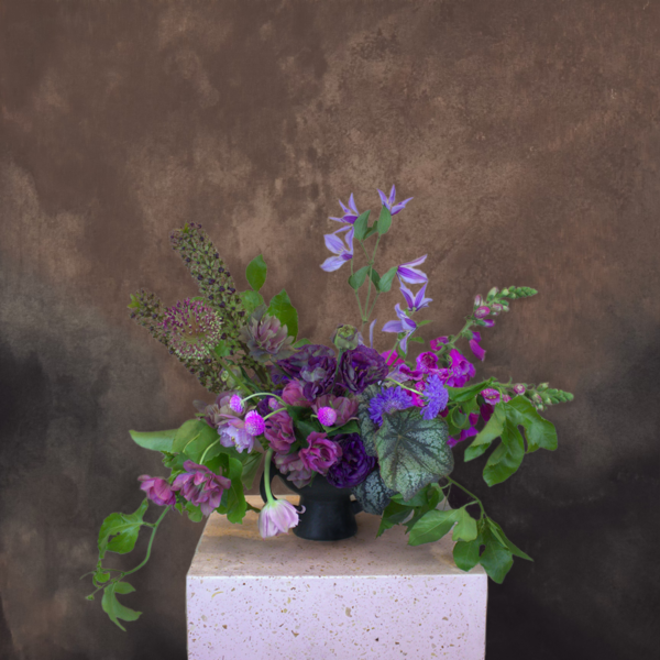 Dark purple floral arrangement for a mysterious, elegant ambiance, perfect for evening events.