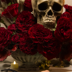 Halloween floral design with deep red flowers, suited for romantic, dark-themed gatherings and decor.