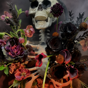 Bold dark-hued Halloween flower display with a gothic flair, perfect for themed parties or decor.