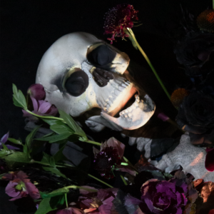 Bold dark-hued Halloween flower display with a gothic flair, perfect for themed parties or decor.