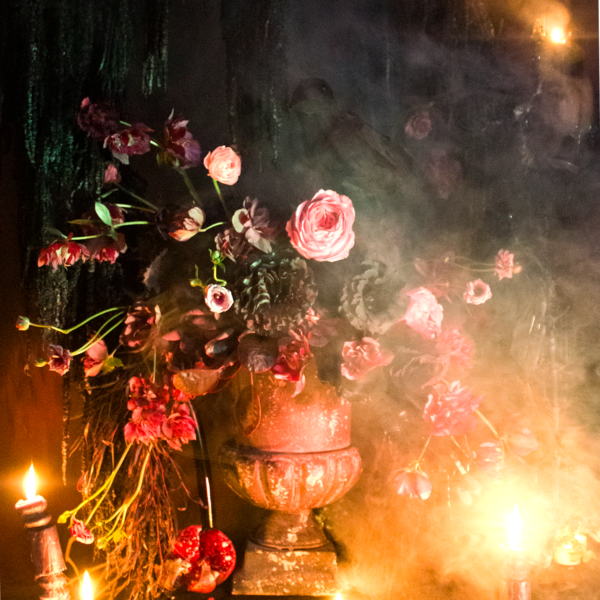 Gothic Halloween floral arrangement with dark blooms, a black raven, and antique-style urn for party decor in Los Angeles.