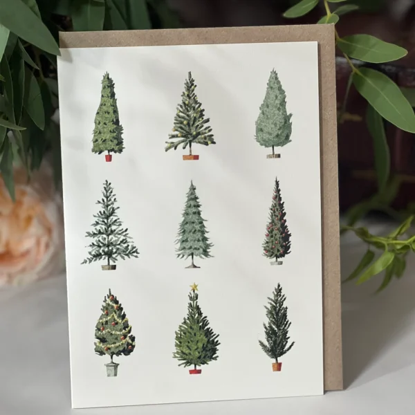 Holiday card displaying a collection of watercolor-style evergreen trees, each uniquely styled, against a white background.