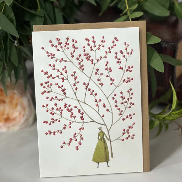 Greeting card featuring a red berry branch with a small figure in a green dress standing beside it, against a white background.